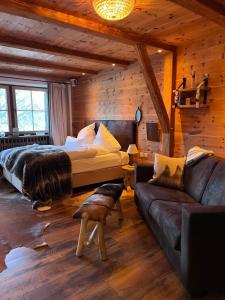 a bedroom with a bed and a couch in a room at Chalet Gipfelblick Inzell in Inzell