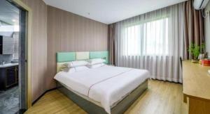 Postel nebo postele na pokoji v ubytování Yiwu Bairui Grand Hotel