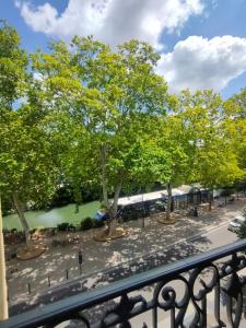a view of a park with trees and a train at Occitania Centre Toulouse Matabiau in Toulouse +14 photos
