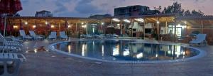 a large swimming pool with chairs and a building at Complex Laguna-Kantardzhiev in Primorsko