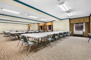 a room with rows of tables and chairs in it at Comfort Inn & Suites North East in North East