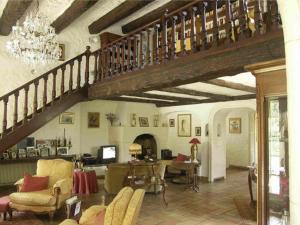 a living room with a staircase and a living room with chairs at Villa l'Air du temps in Juan-les-Pins