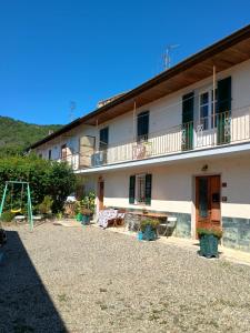 a large white building with a playground in front of it at Casa Vacanza Arzello in Melazzo