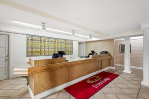 a hotel lobby with a reception desk and a red rug at Econo Lodge Augusta North - Washington Road in Augusta