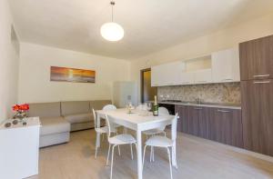 a kitchen and living room with a white table and chairs at La Perla dello Stagnone in Birgi Vecchi