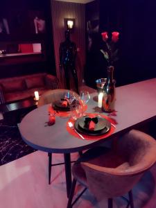 a table with a plate of food on top of it at Love Room, Gîte 4 étoiles, 50 Nuances Romantiques in Villeneuve-en-Retz