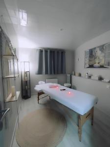 a room with a large white tub in a room at Love Room, Gîte 4 étoiles, 50 Nuances Romantiques in Villeneuve-en-Retz