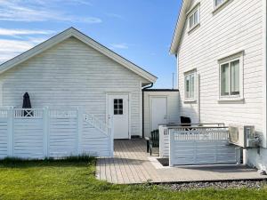 a house with a white fence in front of it at 4 person holiday home in Borhaug in Borhaug