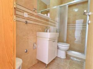 a bathroom with a toilet and a sink and a shower at Apartments Seafront Silence - One Bedroom Apartment with Terrace and Sea View in Trstenik +30 photos