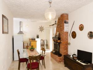 a living room with a table and a fireplace at Holiday Home Jasminka - Three Bedroom Holiday Home with Terrace and Sea View in Potomje