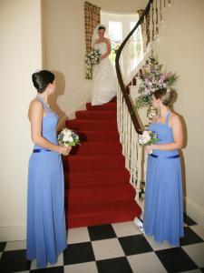 a bride and groom walking down a red carpeted staircase at Rudha-na-Craige in Inveraray