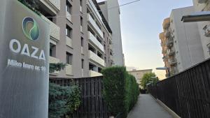 a building with a sign on the side of a sidewalk at Oasis Apartment in Cluj-Napoca