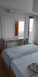 a bedroom with a large bed and a window at Oasis Apartment in Cluj-Napoca