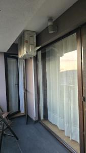 a room with a window and a room with a balcony at Oasis Apartment in Cluj-Napoca