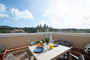 a table with a plate of fruit on a balcony at RIUS - Apartments & one Penthouse with private terrace in Montjuic in Barcelona