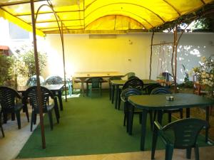 a group of tables and chairs in a restaurant at Guest house Stoyanovi in Chernomorets +44 photos