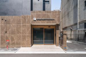 an entrance to a building with a sign on it at Apartment Hotel 11 Nippombashi in Osaka +13 photos