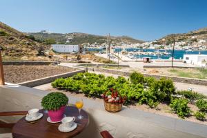 a table on a balcony with a view of a city at Stefanos Studios in Skala