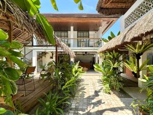 a courtyard of a house with a balcony at Alpas Siargao in General Luna