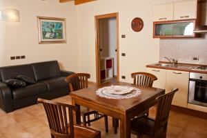 a living room with a table and chairs and a couch at Agriturismo Radaméz in Monzambano