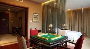 a room with a bed and a table with a pool table at OSOTTO RECREATION HOTEL in Shiken