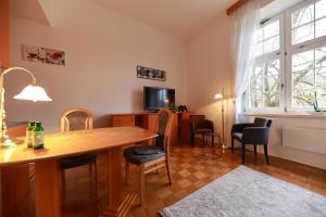 a living room with a wooden table and chairs at Apartments at Villa Golf in Rogaška Slatina