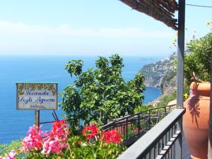 a view of the amalfi coast from a balcony with flowers at Locanda Degli Agrumi in Conca dei Marini