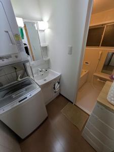 a small white kitchen with a sink and a counter at Villa Otsu by Kyoto ヴィラ大津 by 京都 6人泊 3BR 京都駅10分 大津駅徒歩5分 in Otsu