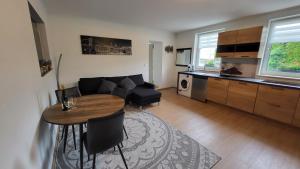a living room with a couch and a table at bei Elena in Burscheid +8 photos