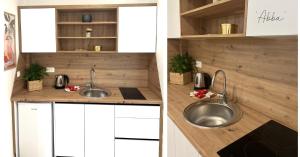 a kitchen with two sinks and white cabinets at Apartment Abba in Međugorje