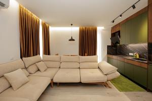 a living room with a couch and a tv at Pomegranate House in Vlorë