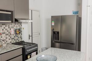 a kitchen with a stove and a refrigerator at SOFT LaNDING in Tatu City