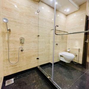 a bathroom with a shower and a toilet in it at Casa Kasauli in Kasauli +40 photos