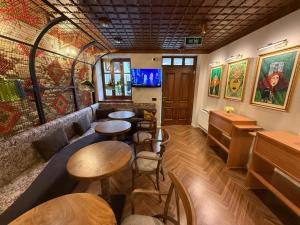 a restaurant with tables and chairs in a room at Nostalgia Boutique Hotel in Gjirokastër