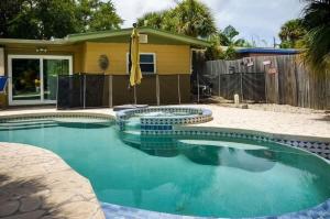 a swimming pool in front of a house at 349 Avenida Madera in Siesta Key