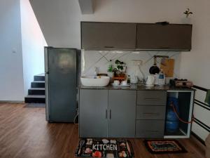 a kitchen with a sink and a refrigerator at Abinu"s Place in Dickwella