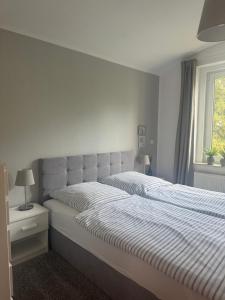 a bedroom with a large bed with a striped comforter at Wohnung Chemnitz-Zentrum in Chemnitz