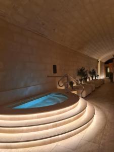 a large jacuzzi tub in a building with lights at Luxurious Level 26 Getaway in St. Julianʼs
