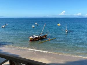 a group of boats in the water on a beach at Villalola in Nosy Be