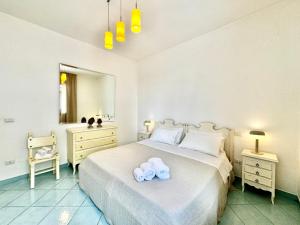 a bedroom with a bed with two towels on it at Casa Appia, fronte mare con giardino - Marea Stays Collection in Nardò