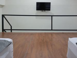 a flat screen tv on top of a white wall at Niti Stay Syariah near Stasiun Wates RedPartner in Wates +26 photos