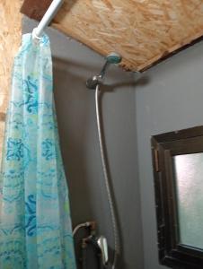 a shower head and a shower curtain in a bathroom at Yurta con uso piscina e vista meravigliosa in Dicomano +35 photos