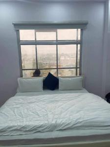 a bed in a room with a large window at The urban inn Hotel in Lucknow