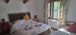 a bedroom with a bed with shoes on it at Maison Provençale avec piscine in Estoublon +35 photos