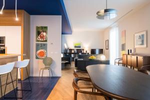 a dining room and living room with a table and chairs at Al Monumento in Modica +39 photos