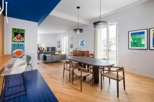 a dining room and living room with a table and chairs at Al Monumento in Modica