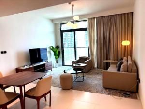 a living room with a couch and a table at Palm View Marina Vista 1BR Beachfront in Dubai