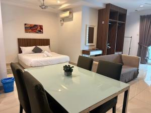 a living room with a table and a bed at Mansion One Seaview Studio 4 pax Gurney in George Town