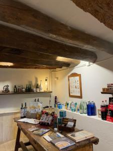 a room with a wooden table with many items on it at El Ventador de la Torra in Lladurs