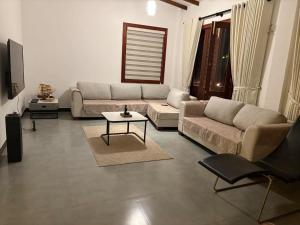 a living room with a couch and a table at Taku Home Stay in Kandy +14 photos